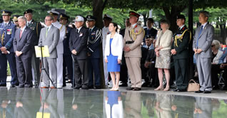 group of people, some in uniform, at ceremony